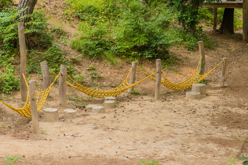 Hanging rope bridge in public park.
