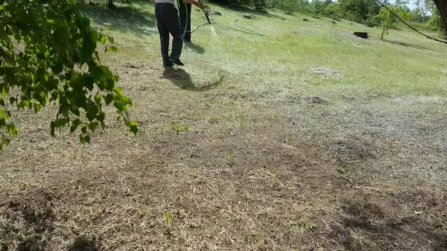 Hydroseeding of lawn grass on the lawn of a country house. High quality 4k footage