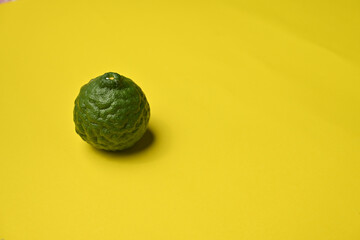 Fresh kaffir lime ( bergamot / citrus hystrix D.C ) isolated on colorful background