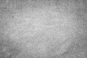 Grunge concrete background with a vignette and a porous texture in the form of small dots resembling granite