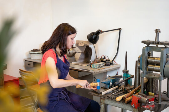 Woman making jewelry in workshop