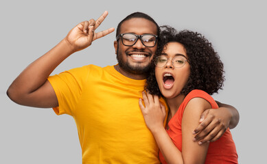relationships, vision and people concept - happy african american couple in glasses hugging over...
