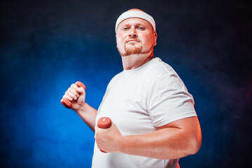 Fat man is training with dumbbell. He is wearing a white tracksuit and handband. The backgroung is very contrast