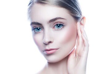 Obraz premium Studio portrait of attractive blonde haired young woman with blue eyes and nude professional make-up holding hand near face, white background