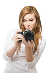 Photography is fun! Young beautiful woman photographer taking images with digital camera and smiling. Isolated on white