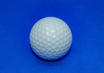 
Bright golf ball on a blue background