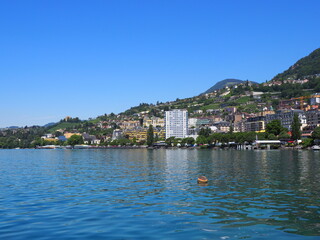 Fototapeta na wymiar View to Lake Geneva and european Montreux city in canton Vaud in Switzerland, clear blue sky in 2017 warm sunny summer day on July.