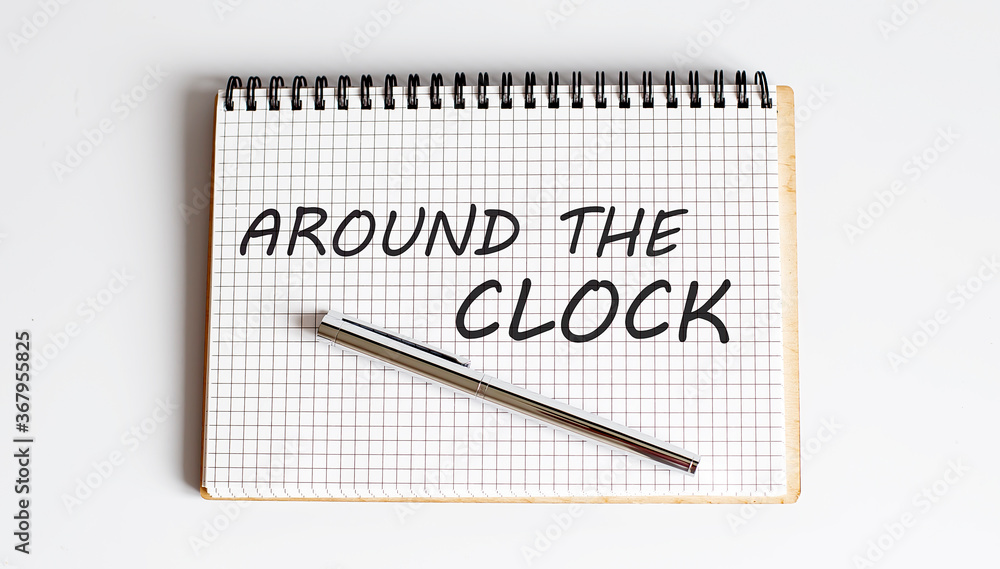 Poster around the clock text written on a notebook with pen