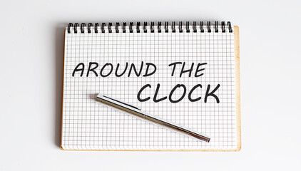 AROUND THE CLOCK text written on a notebook with pen