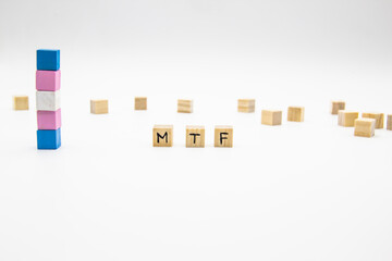 MTF lettering made of wooden cubes and transgender flag on white background. Conceptual illustration lesbian, gay, bisexual, and transgender