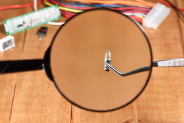 Light bulb under the magnifying glass, close up.