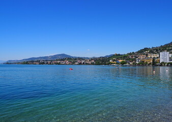 Panoramic view of Lake Geneva and european Montreux city in canton Vaud in Switzerland, clear blue sky in 2017 warm sunny summer day on July.