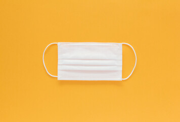 Stock photo of an isolated face mask on a yellow background