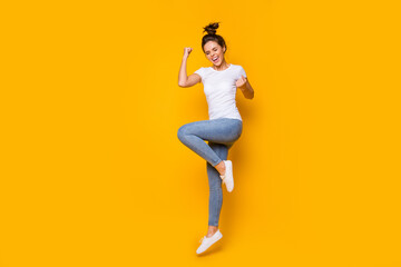 Fototapeta na wymiar Full length body size view of her she nice attractive lovely slim fit overjoyed cheerful cheery girl jumping celebrating great luck isolated over bright vivid shine vibrant yellow color background