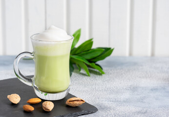 Matcha cappuccino with almond milk cup close-up