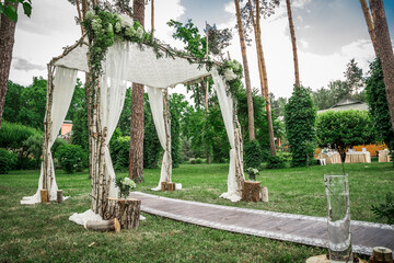 
Arch for holding a Jewish wedding in a pine forest.