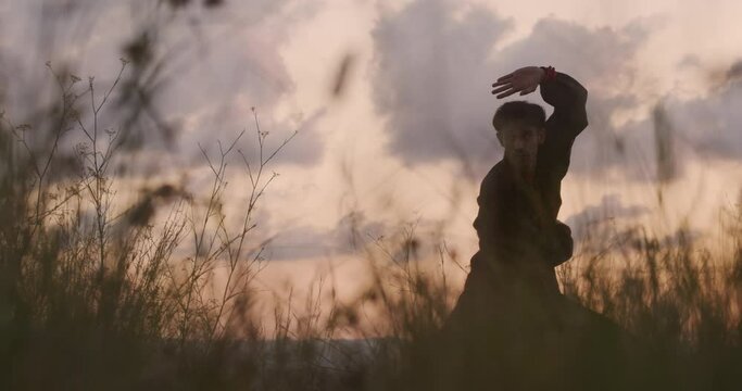 Man during a sunset practicing martial arts. Chi kung, kung fu, self-knowledge