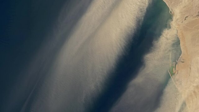 Sand storm aerial satellite view, dust stream from desert to ocean powerful wind animation, Namibia desert. Images furnished by Nasa