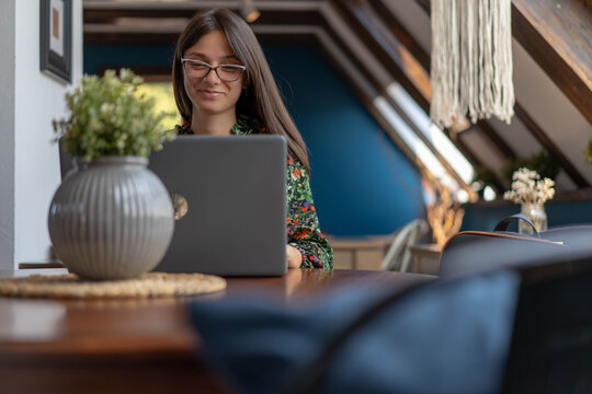 Young woman watching funny content on her lap top compter. Happy woman concept