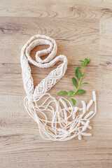 Handmade macrame dress belt closeup details. Natural cotton threads. Stylish decoration for women 's dress.  Female hobby. ECO friendly modern knitting DIY natural decoration concept.