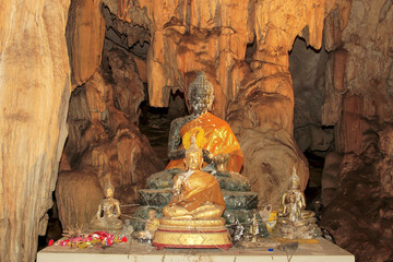 Buddhastatue  inLava tube, stalactite cave near Kanchanaburi, Thailand, Asia