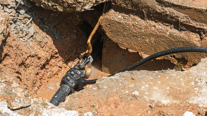 Severe water leaks from old cracked pipes in all directions.