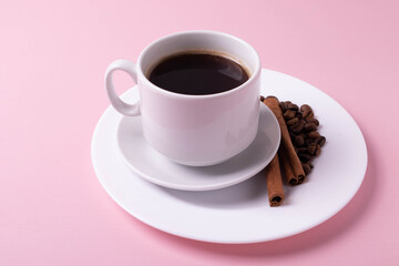 espresso in a white ceramic cup on pink