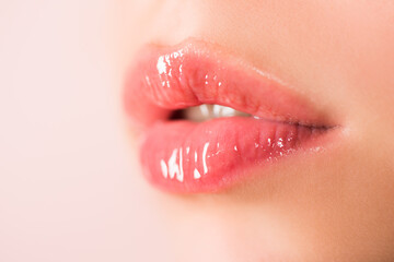 Natural beauty lip care. Female lips with pink lipstick. Sensual tenderness womens open mouths. Red lip with glossy lipgloss. Close up, macro with beautiful mouths. Sensual lips of a young woman. - obrazy, fototapety, plakaty
