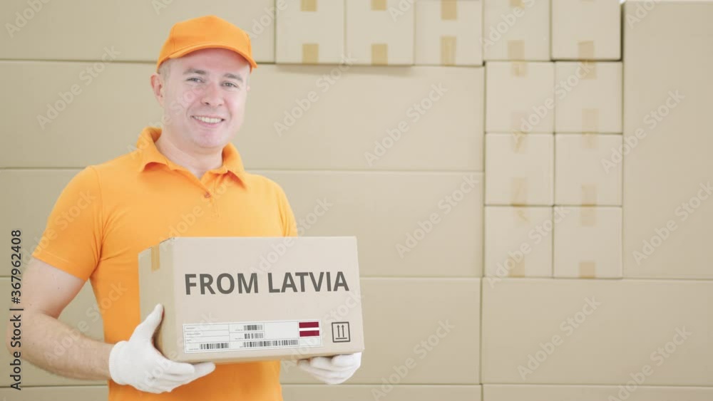Poster warehouse worker holds parcel with from latvia text on it