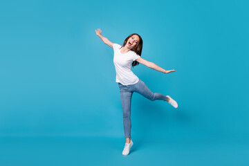 Full length body size view of her she attractive pretty careless funky slim skinny glad cheerful cheery girl jumping fooling having fun isolated bright vivid shine vibrant blue color background
