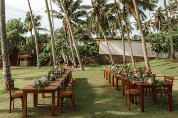 Set tables for a wedding dinner in a tropical garden. Concept of tropical wedding