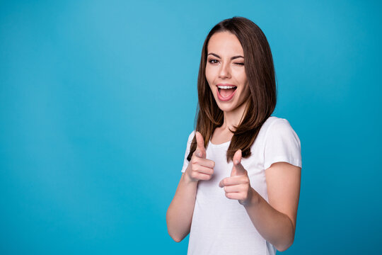 I Pick You. Photo Of Attractive Pretty Funny Lady Good Mood Charming Appearance Wink Eye Handsome Guy Direct Finger On Camera Wear Casual White T-shirt Isolated Blue Color Background