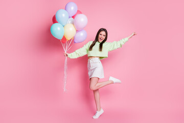 Full length photo of attractive lady arrange birthday party friend hold many air balloons meet...