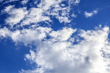 Clear blue sky with white clouds.