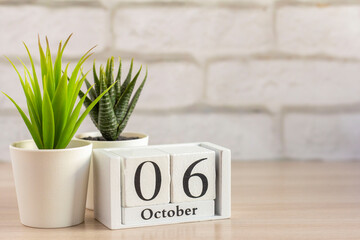 October 6 on a wooden calendar on a table or shelf.One day of the autumn month.Calendar for October. Autumn