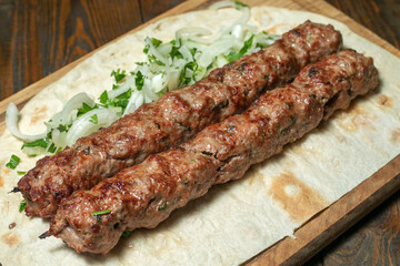 lula kebab with herbs on a wooden surface - 367967413