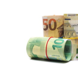 Money rolls, rolled up euro banknotes, bills of various monetary values tied up with rubber band isolated on white background
