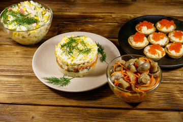 Set of various festive dishes on a wooden table