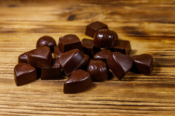 Tasty chocolate candies on wooden table
