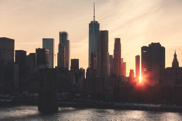 Fototapeta premium Retro toned picture of Manhattan skyline silhouette at sunset, New York City, USA.