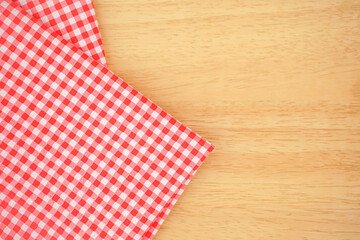 Obraz premium Classic pink plaid fabric or tablecloth fold on wood desk with copy space
