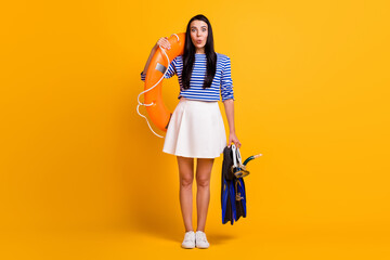 Full size photo of positive girl tourist enjoy scuba diving water sport hold life buoy goggles mask tube flippers wear blue white dress skirt shirt isolated bright shine color background