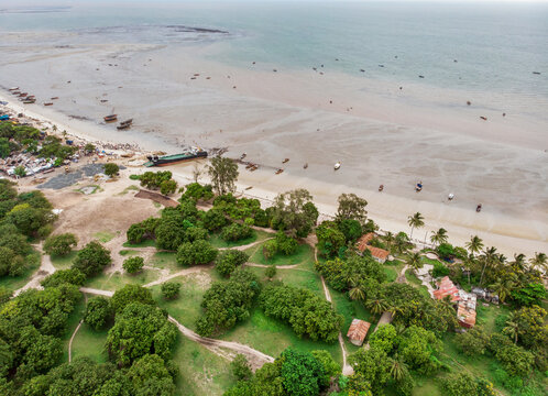 An aerial shot of Bagamoyo, Tanzania. Curve of Indian Ocean Beachline Coast with Vessels