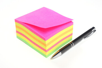 block of colored sticky notes and a pen isolated on white background with copy space for your text