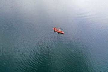 Fototapeta premium Kayak floats on the river view from the top, from the drone, two guys in the canoe
