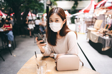 Young adult asian woman wear mask for new normal lifestyle protect from corona virus