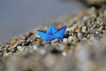 a small blue ship stands on the sea