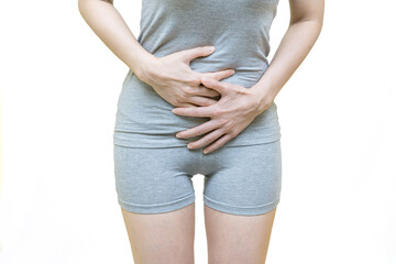 low body of a woman in gray clothes put her hands on the Stomach area at spot of ache, abdominal pain, Health-care concept on white background