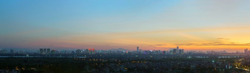 Fototapeta na wymiar Panorama cityscape of Hanoi skyline at Vinh Tuy bridge over Red river during sunset time