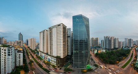 Naklejka premium Cityscape of Hanoi skyline at Le Van Luong - Hoang Minh Giam intersection during sunset time in Hanoi city, Vietnam